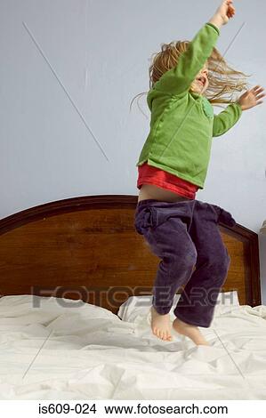 Girl jumping on bed View Large Photo Image Picture - Girl jumping on bed. Fotosearch