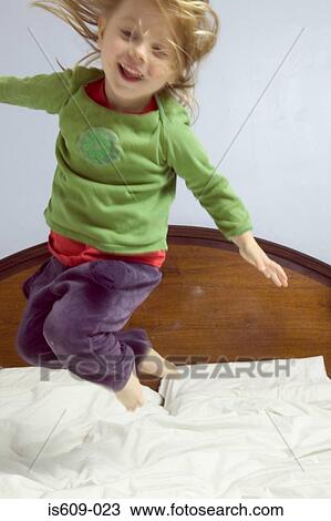 Girl jumping on bed View Large Photo Image Stock Image - Girl jumping on bed. Fotosearch