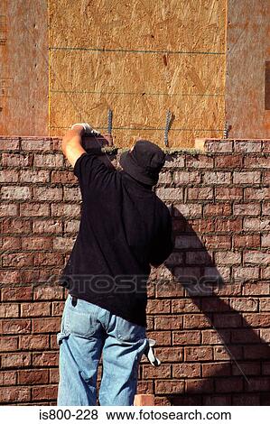 Man building a brick wall View Large Photo Image Stock Photo - Man building a brick wall. Fotosearch