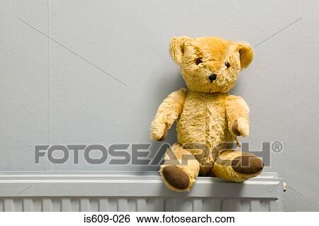 Teddy bear on radiator View Large Photo Image Stock Photograph - Teddy bear on radiator. Fotosearch