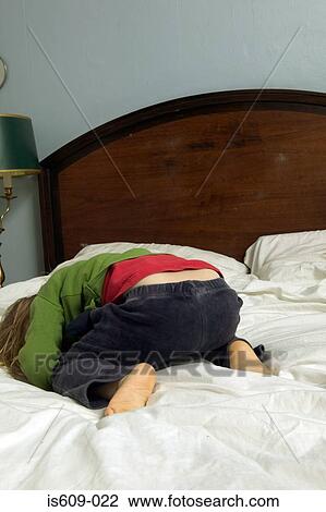 Young girl crying on bed View Large Photo Image Stock Image - Young girl crying on bed. Fotosearch