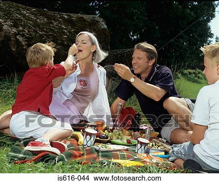 Family having fun at picnic. View Large Photo Image Picture - Family having fun at picnic.. Fotosearch