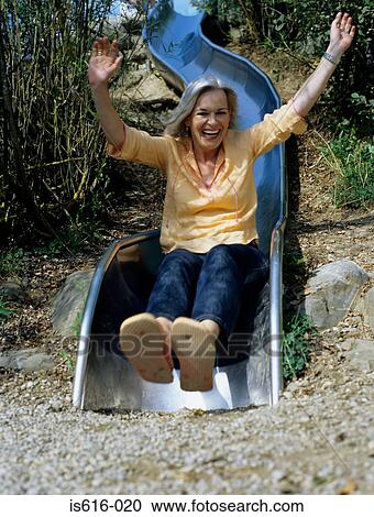 Laughing woman on slide. View Large Photo Image Stock Image - Laughing woman on slide.. Fotosearch