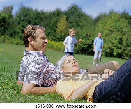 Stock Photography - Parents relax while boys play.. Fotosearch - Search Stock Photos, Pictures, Wall Murals, Images, and Photo Clipart