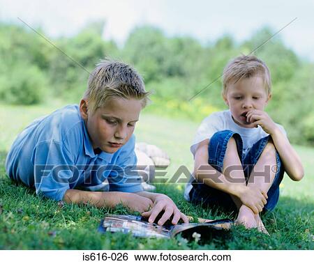Two boys relaxing outdoors. View Large Photo Image Stock Photograph - Two boys relaxing outdoors.. Fotosearch