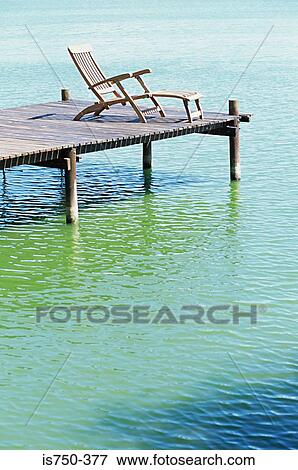 Stock Photo - Deckchair on a jetty. Fotosearch