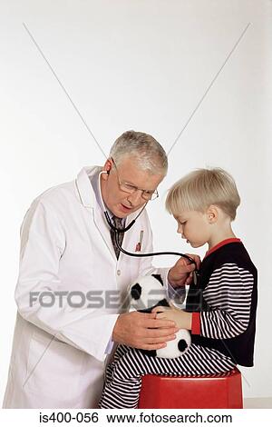 Stock Photograph - Doctor listening to boy's chest. Fotosearch