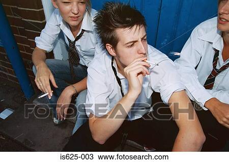 Stock Image - High school students smoking cigarettes. Fotosearch