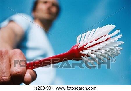 Man holding scrubbing brush View Large Photo Image Stock Photo - Man holding scrubbing brush. Fotosearch