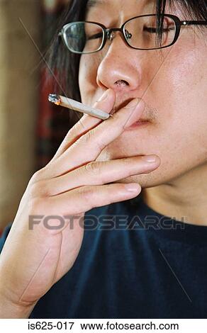 Man smoking marijuana View Large Photo Image Stock Photo - Man smoking marijuana. Fotosearch