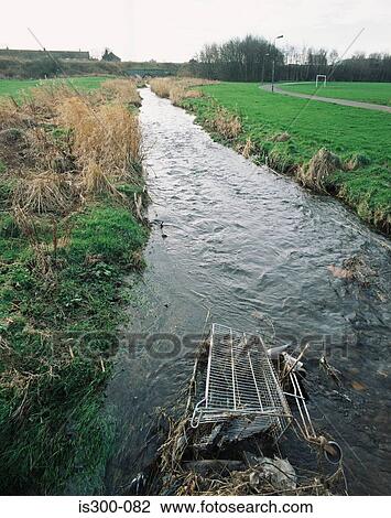 Stock Image - Shopping trolley in a stream. Fotosearch