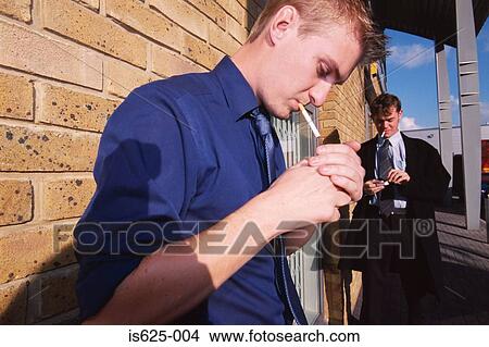 Picture - Two young men smoking. Fotosearch