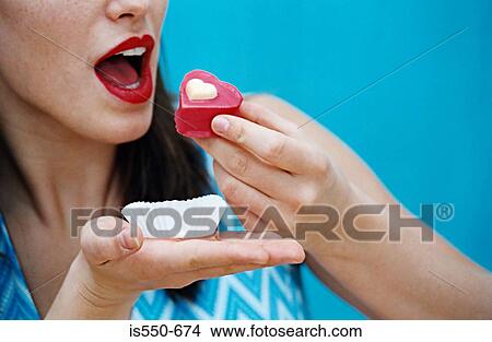 Woman about to eat a cupcake View Large Photo Image Picture - Woman about to eat a cupcake. Fotosearch