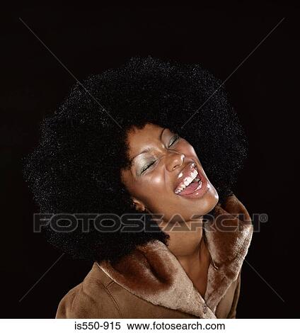 Stock Photography - Woman in fur coat laughing. Fotosearch