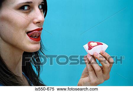 Woman licking her lips with cake View Large Photo Image Stock Photography - Woman licking her lips with cake . Fotosearch