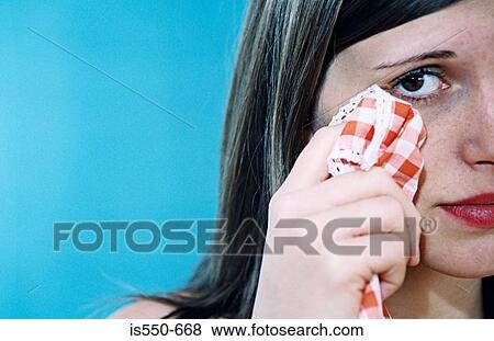 Woman wiping her eye View Large Photo Image Stock Photo - Woman wiping her eye. Fotosearch