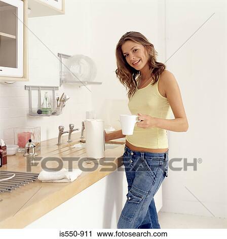 Young woman making hot drink View Large Photo Image Stock Image - Young woman making hot drink. Fotosearch