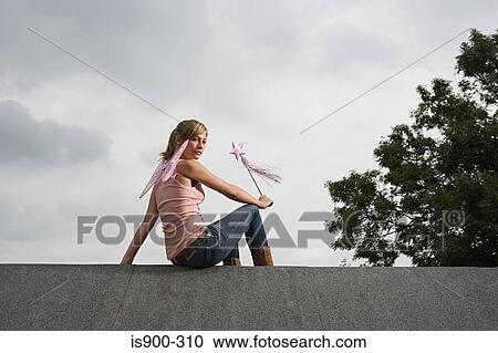Angel sitting on a roof View Large Photo Image Stock Image - Angel sitting on a roof. Fotosearch