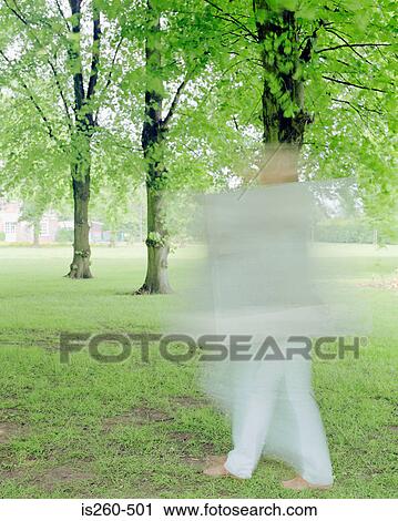 Blurred person in park View Large Photo Image Stock Image - Blurred person in park. Fotosearch
