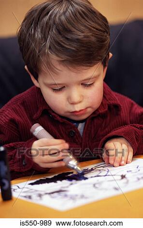 Stock Photo - Boy drawing a picture. Fotosearch