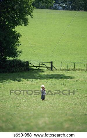 Boy lost in a field View Large Photo Image Stock Photo - Boy lost in a field. Fotosearch