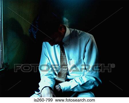 Businessman sitting in shadows View Large Photo Image Stock Photo - Businessman sitting in shadows. Fotosearch