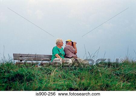 Stock Photograph - Elderly couple using binoculars. Fotosearch