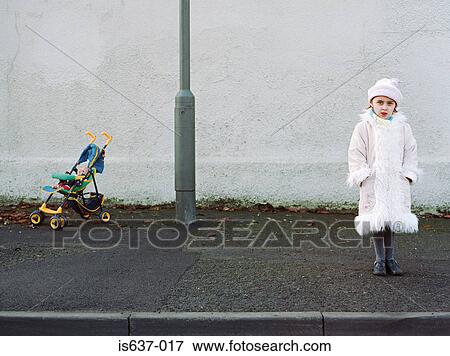 Stock Photo - Girl and toy pushchair. Fotosearch