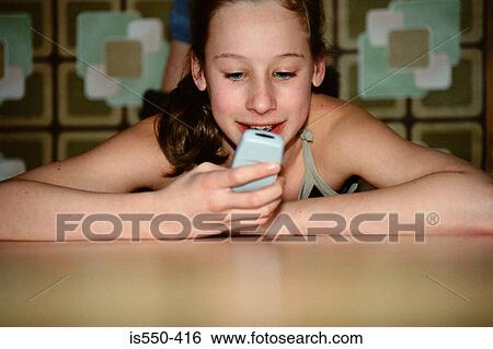 Girl text messaging View Large Photo Image Stock Photograph - Girl text messaging. Fotosearch