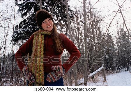Picture - Girl with hands on hips in snow. Fotosearch