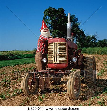 Gnome leaning on a tractor View Large Photo Image Stock Image - Gnome leaning on a tractor . Fotosearch