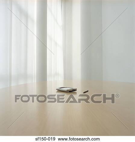 Stock Photo - Handheld computer on desk. Fotosearch