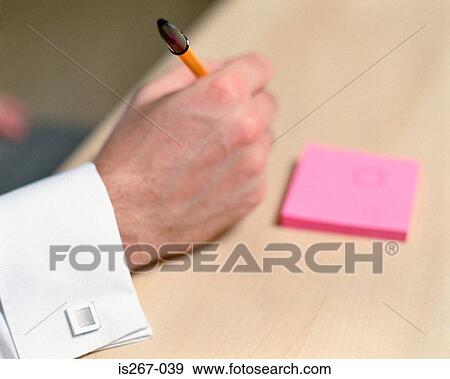 Man writing on square pad View Large Photo Image Stock Photo - Man writing on square pad. Fotosearch