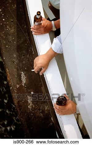 Men drinking and smoking on balcony View Large Photo Image Stock Photograph - Men drinking and smoking on balcony. Fotosearch