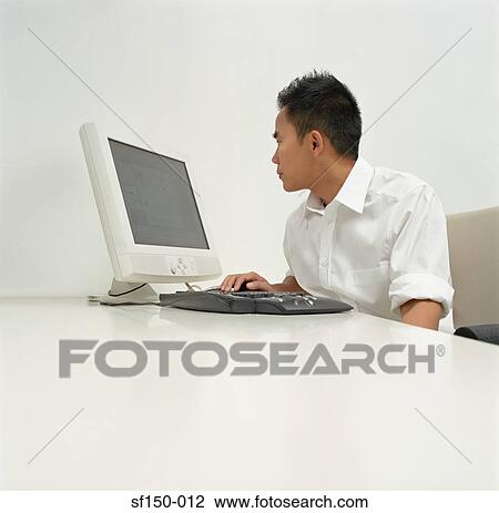 Office worker using computer View Large Photo Image Stock Image - Office worker using computer. Fotosearch