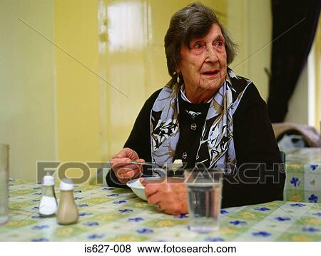 Senior woman eating pudding View Large Photo Image Stock Photo - Senior woman eating pudding. Fotosearch