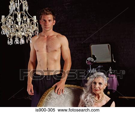 Senior woman sitting with partially clothed young man standing View Large Photo Image Stock Photography - Senior woman sitting with partially clothed young man standing. Fotosearch