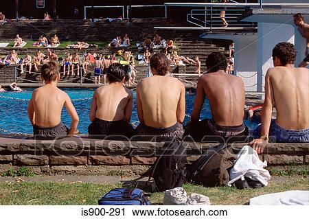 Stock Image - Teenage boys waiting by pool. Fotosearch