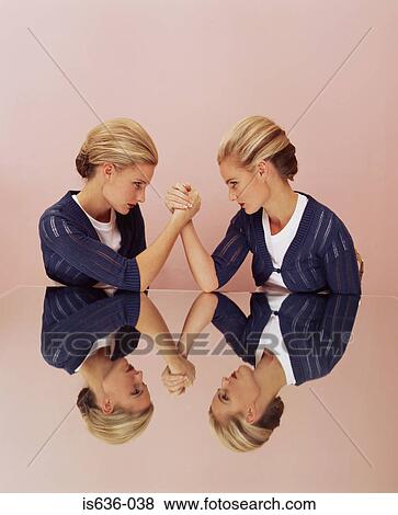 Two women arm wrestling View Large Photo Image Stock Photo - Two women arm wrestling. Fotosearch