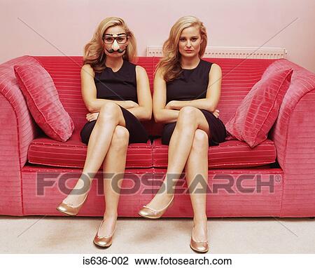 Two women on a sofa one wearing a comedy disguise View Large Photo Image Stock Image - Two women on a sofa one wearing a comedy disguise. Fotosearch