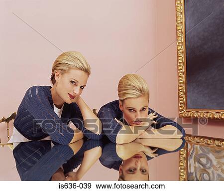 Two women sitting at a table View Large Photo Image Stock Photo - Two women sitting at a table . Fotosearch