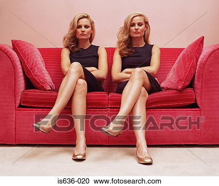 Two women with arms crossed on a sofa View Large Photo Image Stock Image - Two women with arms crossed on a sofa. Fotosearch