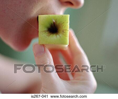 Woman eating square apple View Large Photo Image Stock Image - Woman eating square apple. Fotosearch