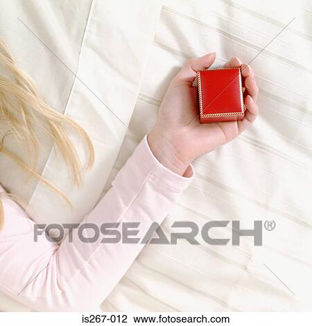 Woman holding a square jewelry box View Large Photo Image Stock Image - Woman holding a square jewelry box. Fotosearch