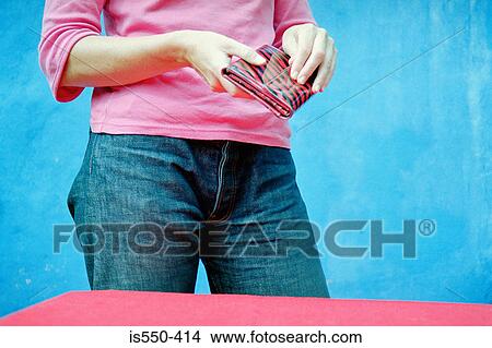 Picture - Woman holding a wallet. Fotosearch