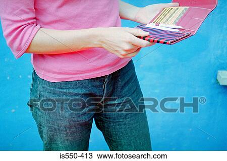 Woman holding a wallet View Large Photo Image Stock Image - Woman holding a wallet. Fotosearch