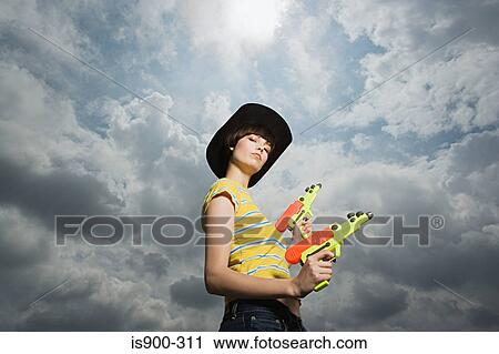 Woman playing with toy guns View Large Photo Image Stock Image - Woman playing with toy guns. Fotosearch