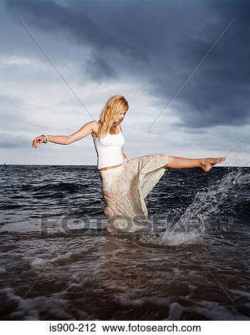 Woman splashing in sea View Large Photo Image Stock Image - Woman splashing in sea. Fotosearch