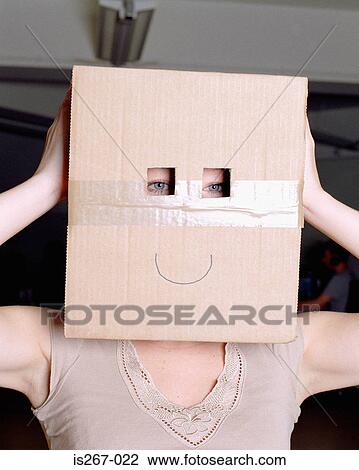 Woman wearing a cardboard box on head View Large Photo Image Stock Image - Woman wearing a cardboard box on head. Fotosearch