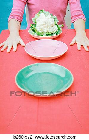 Stock Image - Woman with cauliflower. Fotosearch